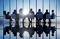 Silhouette of people sitting around a table